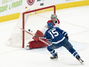 Maple Leafs centre Alexander Kerfoot (15) shoots against Montreal Canadiens goaltender Carey Price (31) during the first period at Scotiabank Arena on Saturday, Feb. 13, 2021, in Toronto.