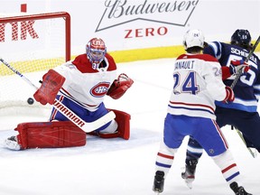 Canadiens goaltender Carey Price makes save on shot by the Jets’ Mark Scheifele during first period of Thursday night’s game at Winnipeg’s Bell MTS Place.