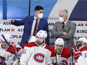 Montreal Canadiens assistant coach Alex Burrows and head coach Dominique Ducharme discuss a play during the first period against the Winnipeg Jets at Bell MTS Place in Winnipeg on Feb. 25, 2021.