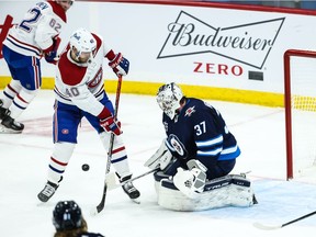 Montreal Canadiens forward Joel Armia (40) misses a rebound off Winnipeg Jets goalie Connor Hellebuyck (37) during the third period at Bell MTS Place. Mandatory Credit: Terrence Lee-USA TODAY Sports