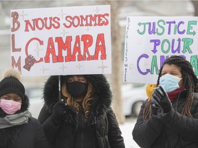People attend a protest called "We are all Camara" in Montreal, Saturday, Feb. 13, 2021, calling for justice for Mamadi III Fara Camara, a man who was wrongfully arrested by police and jailed for six days.