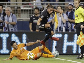 Sporting Kansas City forward Erik Hurtado leaps over Houston Dynamo midfielder Memo Rodriguez during the first half on Aug. 31, 2019, in Kansas City.
