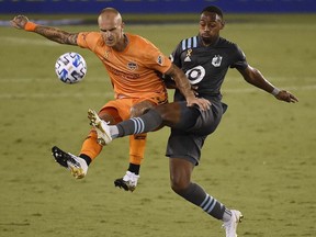 Houston Dynamo defender Aljaz Struna, left, and Minnesota United forward Mason Toye fight for possession during the second half of on Sept. 19, 2020, in Houston.