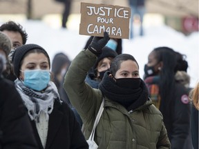 People take part in a protest to denounce police abuses and in support of Mamadi Fara Camara and his family on Friday, Feb. 5, 2021, in Montreal. Camara was released after being arrested and detained for six days after being  accused in an assault on a police officer last week.