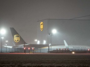 Snow falls at the United Parcel Service (UPS) WorldPort hub located at Louisville Muhammad Ali International Airport in Louisville, Kentucky, U.S., February 15, 2021. For the first time in history, UPS has closed the WorldPort hub,  suspending all sorting and flight operations because of weather. REUTERS/Bryan Woolston