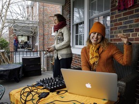 Kristy Chavez-Fernandez, right, and her mother Raquel Chavez-Fernandez, who are self-isolating at home due to coronavirus concerns, dance together on their porch as Kristy plays music for neighbors to enjoy at a "social distancing block party," Wednesday, March 18, 2020, in Washington, complete with music and dancing, all from at least 6 feet away per household. "This block has a deep history and intergenerational community," says Kristy Chavez-Fernandez, "my neighbor and friend Harriet Segar and I collaborated to create a joyful space together for our block."