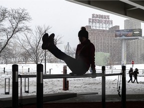 Montrealers woke up to a snowy morning on Saturday February 27, 2021. Justine Doyon works out on the parallel bars at the workout station in Old Montreal.  Dave Sidaway / Montreal Gazette ORG XMIT: 65813