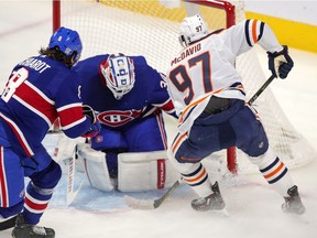 Montreal Canadiens' Jake Allen stops a shot by Edmonton Oilers star Connor McDavid as Ben Chiarot trails during first period in Montreal on Feb. 11, 2021.