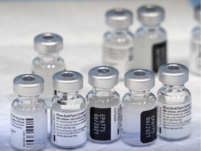 Vials of the Pfizer-BioNTech COVID-19 vaccine are readied for distribution to nurses on the floor of the vaccination centre setup inside the Palais des congres, in Montreal, on Monday, March 1, 2021.