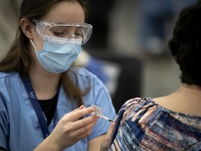 A healthcare worker administers the COVID-19 vaccine at a vaccination centre at the Palais des congres in Montreal, March 1, 2021.