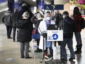 First stop after walking into the Olympic Stadium is registration with the Quebec health card on the first day of vaccination for COVID-19 March 1, 2021.