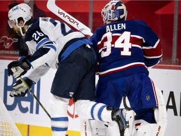 Winnipeg Jets right wing Blake Wheeler brushes up against Montreal Canadiens goaltender Jake Allen behind the net during second period in Montreal on Thursday, March 4, 2021.