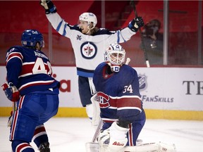 Jets' Kyle Connor celebrates as Canadiens goaltender Jake Allen looks back in to the net after the Winnipeg scored the winning goal in overtime Thursday night at the Bell Centre.