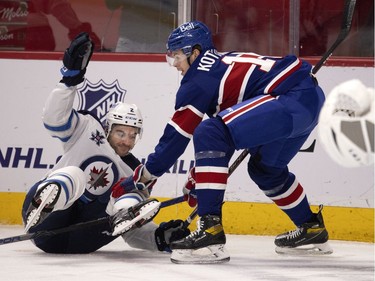 Montreal Canadiens centre Jesperi Kotkaniemi dumps Winnipeg Jets defenseman Dylan DeMelo in the first period at the Bell Centre on Thursday, March 4, 2021.