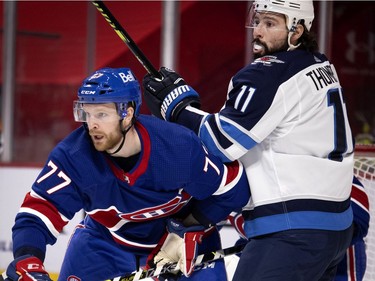 Montreal Canadiens defenseman Brett Kulak ties up Winnipeg Jets centre Nate Thompson in front of the net during second period in Montreal on Thursday, March 4, 2021.
