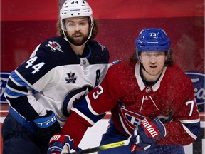 Winnipeg Jets defenceman Josh Morrissey holds on to Montreal Canadiens right-wing Tyler Toffoli in Montreal on March 6, 2021.