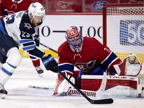 Montreal Canadiens goaltender Carey Price follows Winnipeg Jets centreTrevor Lewis in Montreal on March 6, 2021.