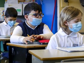 Students wear masks in class at John Caboto Academy in the Ahuntsic district of Montreal on March 8, 2021. The provincial government sent out a directive on Friday, March 26, 2021, saying the SNN200642 masks made by Quebec company Metallifer and distributed to some Quebec schools and daycares have "a potential for early lung toxicity," according to a report from Radio-Canada.