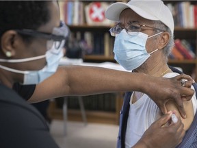 Pierre Marie Toussaint receives the Moderna vaccine from nurse Marie Clodain at Manoir Aimé-Léonard on Thursday March 11, 2021.