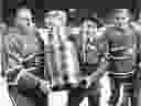 Former head coach of the Canadiens Hector (Toe) Blake, centre, gets helping hand from Maurice (Rocket) Richard, left, and Jacques Plante carrying the Stanley Cup on Forum ice on Dec. 17, 1983.  