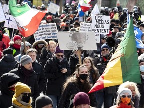 Marchers protest against government health orders to wear masks and social distance in Montreal on Saturday, March 13, 2021.