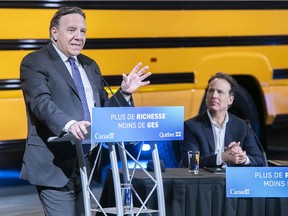 Lion Electric president Marc Bédard listens to Quebec Premier François Legault during announcement on a combined Quebec-Canada $100-million investment in Lion Electric on Monday March 15, 2021 during the COVID-19 pandemic.