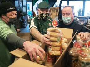 Joe Cannon, left, and Paul Quinn, centre, of the Irish Embassy Pub will provide breakfast and lunch on St. Patrick's Day at the Resilience Montreal shelter, including bagels courtesy of Jimmy Rennie, right, of Ville-Émard Bagels.