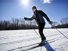 Roger Quirion cross-country skis on a sunny day at the Cap-St-Jacques nature park in the Pierrefonds borough of Montreal Monday March 15, 2021.