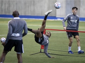 FC Montréal's Ride Zouhir gets upside down to return the ball to Montreal Impact midfielder Mathieu Choinière as they take part in training camp in Montreal on March 17, 2021.