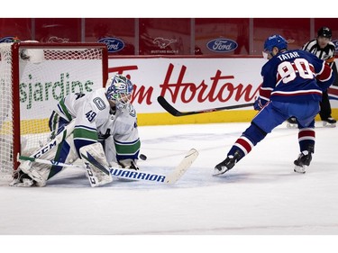 Canadiens' Tomas Tatar (90) backhands the puck past Vancouver Canucks goaltender Braden Holtby to win the game 5-4 in shootout during NHL action in Montreal on Saturday, March 20, 2021.