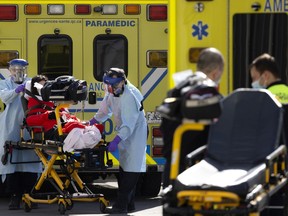 As one ambulance prepares to leave, another arrives at the busy Notre-Dame Hospital emergency room on Tuesday.