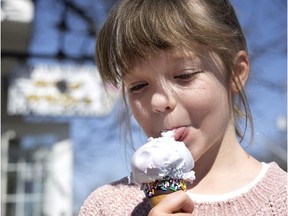 Six-year-old Florence dives into a cotton candy flavoured ice cream cone from Wild Willy's in Pointe-Claire Village, on Monday, March 22.