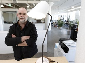 Samuel Lambert, founder of Montreal lighting design company Lambert & Fils, checks out one of his products, made on site, in Montreal, on Thursday, March 25, 2021.