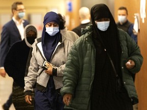 Members of Ali Ngarukiye's family leave the courtroom in Montreal March 26, 2021.