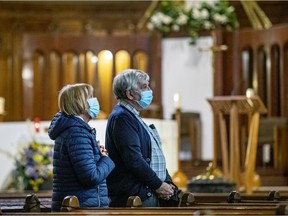 Claude Bergeron and Marie-Margarite Houde pray the Stations of the Cross in the crypt church at Saint Joseph's Oratory after it reopened on Friday, March 26, 2021.