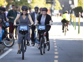 Montreal Mayor Valérie Plante rides a battery-assisted bike in 2019. As global temperatures rise, bike sharing is one activity that may be able to start earlier in the spring and last later in the fall, but any increase in participation is likely to be offset by a decrease during the now hotter summer months, Jill Barker writes.
