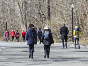 Montrealers walk on Mount Royal in Montreal March 30, 2021.