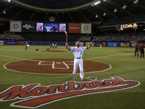 Toronto Blue Jays catcher Russell Martin carries a torch during a ceremony to celebrate the Olympic Stadium's 40th anniversary before an exhibition game against the Boston Red Sox on April 2, 2016. “If tomorrow there were a baseball club in Quebec, there would be players who would pay taxes here — taxes that we wouldn’t have if we didn’t have a baseball club,” Premier François Legault said Tuesday.