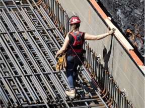 A construction worker installs rebar on a new condo project in August 2020.