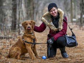 Montreal Gazette columnist Allison Hanes with her dog in the woods near her home in December.