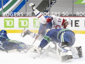 Canadiens forward Paul Byron crashes into Canucks goalie Thatcher Demko during the first period at Rogers Arena.