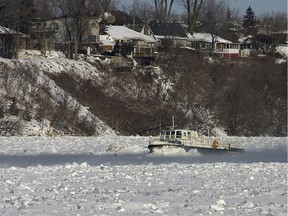 A small boat with Hydro Quebec markings breaks ice along the Rivière Des Prairies near Papineau on Jan. 17, 2007.
