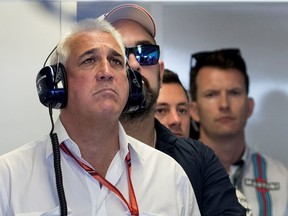 Lawrence Stroll, left, father of then-Williams Racing driver Lance Stroll, follows the action in the Williams garage during the morning practice round during the Canadian Formula 1 Grand Prix at Circuit Gilles Villeneuve in Montreal on Saturday June 10, 2017.