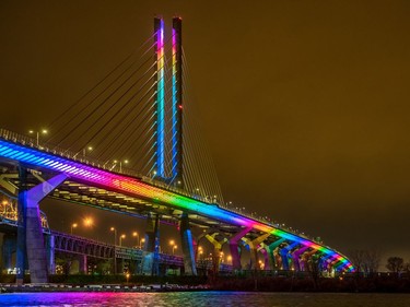 The Samuel de Champlain Bridge is illuminated with the colours of the rainbow on Sunday April 26, 2020.