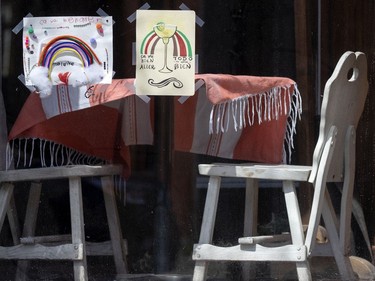 Rainbow drawings are taped to the window of  El Sabor de Mexico, on Wellington Street in Montreal, on May 21, 2020.