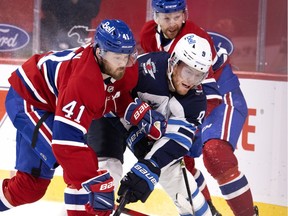 MONTREAL, QUE.: March 6, 2021 -- Winnipeg Jets center Andrew Copp (9) gets squeezed by Montreal Canadiens right wing Paul Byron (41), left, and Montreal Canadiens defenseman Brett Kulak (77) during NHL action in Montreal on Saturday, March 6, 2021.  (Allen McInnis / MONTREAL GAZETTE) ORG XMIT: 65846