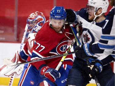 MONTREAL, QUE.: March 6, 2021 -- Montreal Canadiens defenseman Brett Kulak (77) leans into Winnipeg Jets center Andrew Copp (9) during NHL action in Montreal on Saturday, March 6, 2021.  (Allen McInnis / MONTREAL GAZETTE) ORG XMIT: 65846