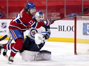 Canadiens'Josh Anderson (17) narrowly misses Winnipeg Jets goaltender Laurent Brossoit (30) during NHL action in Montreal on Saturday, March 6, 2021.