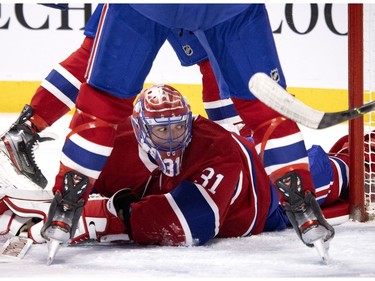 Canadiens goaltender Carey Price keeps his eye on the puck in heavy traffic during NHL action against the Winnipeg Jets in Montreal on Saturday, March 6, 2021.