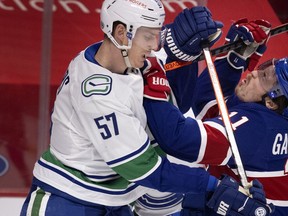 Canadiens' Brendan Gallagher (11) reacts after taking a stick to the face from Vancouver Canucks defenceman Tyler Myers (57) during NHL action in Montreal on Saturday, March 20, 2021.